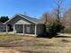 Quaint home with gray siding, a brick chimney, and a small covered front porch perfect for enjoying the outdoors at 188 13Th Se St, Hickory, NC 28602