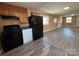 Updated kitchen with black appliances, wood cabinets, and durable laminate flooring at 188 13Th Se St, Hickory, NC 28602