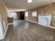 Open living room featuring neutral walls, fireplace, and durable laminate flooring at 188 13Th Se St, Hickory, NC 28602