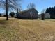 Home exterior with a brick chimney, wooden deck, lush yard, and mature trees in a quiet setting at 188 13Th Se St, Hickory, NC 28602