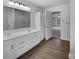Bathroom showcasing a double vanity and wood-look flooring with a large mirror at 1913 Leesburg Dr, Clover, SC 29710