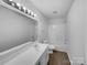 Bright bathroom features a sleek vanity, mirror, and shower-tub combo for functionality at 1913 Leesburg Dr, Clover, SC 29710