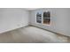 Bright, spacious bedroom with neutral carpet, ample natural light, and minimalist decor at 1913 Leesburg Dr, Clover, SC 29710