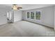 Spacious carpeted bedroom featuring three large windows and a ceiling fan at 1913 Leesburg Dr, Clover, SC 29710