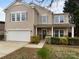 Charming two-story home with a well-manicured lawn and an attached two-car garage at 1913 Leesburg Dr, Clover, SC 29710
