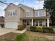 Charming two-story home with a well-manicured lawn and an attached two-car garage at 1913 Leesburg Dr, Clover, SC 29710