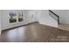 Spacious, light-filled living room with vinyl flooring and stairs to the second floor at 1913 Leesburg Dr, Clover, SC 29710