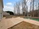Backyard with an in-ground pool, patio, and shed surrounded by mature trees at 1913 Leesburg Dr, Clover, SC 29710