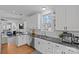 Bright kitchen with stainless steel appliances, granite countertops, and white cabinetry at 2212 Yadkin Ave, Charlotte, NC 28205