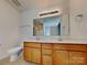 Bathroom with double sink vanity, large mirror, and neutral color scheme at 242 Elrosa Rd, Mooresville, NC 28115
