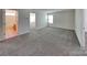 Spacious bedroom features neutral carpeting, ample natural light, and access to an attached bathroom at 242 Elrosa Rd, Mooresville, NC 28115