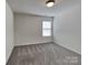 Bedroom with neutral carpet, light walls, and one window providing ample natural light at 242 Elrosa Rd, Mooresville, NC 28115