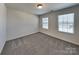 Cozy bedroom featuring neutral carpet, light walls, and windows for natural light at 242 Elrosa Rd, Mooresville, NC 28115