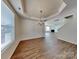 Open dining area leading into a living room with a cozy fireplace and lovely wood floors at 242 Elrosa Rd, Mooresville, NC 28115