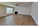Bright living room featuring beautiful wood flooring and a cozy fireplace at 242 Elrosa Rd, Mooresville, NC 28115