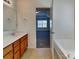 Clean main bathroom with double vanity, a large mirror, and a separate tub room at 242 Elrosa Rd, Mooresville, NC 28115