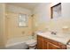 Bathroom featuring tiled walls, a bath tub, a toilet, and a vanity with fixtures, ripe for renovation at 2519 Arnold Dr, Monroe, NC 28110