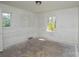 A bedroom with original windows providing natural light, awaiting renovation at 2519 Arnold Dr, Monroe, NC 28110