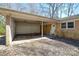 Attached carport with a storage room and parking, showing a brick exterior and covered parking area at 2519 Arnold Dr, Monroe, NC 28110
