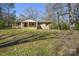 Charming single-story home with a brick facade and a covered front porch, surrounded by a lawn at 2519 Arnold Dr, Monroe, NC 28110