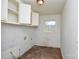 Inside laundry room featuring cabinets, sink fixtures, and a window providing natural light at 2519 Arnold Dr, Monroe, NC 28110