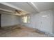 Bright living room with white walls, a ceiling fan, and large windows, offering ample natural light at 2519 Arnold Dr, Monroe, NC 28110