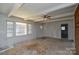Spacious living room featuring white walls, a ceiling fan, and natural light from large windows at 2519 Arnold Dr, Monroe, NC 28110