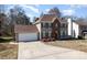 Lovely home with a two-car garage, red front door and a well-kept lawn at 2532 Pimpernel Rd, Charlotte, NC 28213