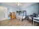 Charming bedroom with a bunk bed, desk, guitar, and wood-look flooring at 257 Notable Ln, Rock Hill, SC 29732