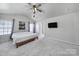Bright bedroom featuring a ceiling fan, two windows, and an entrance to the main bathroom at 257 Notable Ln, Rock Hill, SC 29732