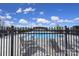 Community pool area featuring an inviting swimming pool, lounge chairs, and tables under a bright blue sky with fluffy clouds at 257 Notable Ln, Rock Hill, SC 29732