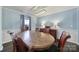 A dining room featuring light blue walls, a light fixture, and a large oval wooden table at 257 Notable Ln, Rock Hill, SC 29732