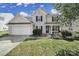 Charming two-story home with a well-manicured lawn, attached garage, and inviting front porch with black shutters at 257 Notable Ln, Rock Hill, SC 29732