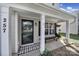 Inviting front porch with black door, a cozy bench, and a stylish buffalo check doormat for a welcoming touch at 257 Notable Ln, Rock Hill, SC 29732