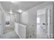 Bright hallway with neutral walls, carpet, and white railing near a bedroom at 257 Notable Ln, Rock Hill, SC 29732