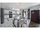 Kitchen with white cabinets, an island with seating, black appliances, and a tile floor at 257 Notable Ln, Rock Hill, SC 29732