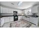 Bright kitchen with white cabinets, stainless steel appliances and a colorful area rug at 257 Notable Ln, Rock Hill, SC 29732