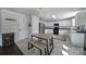 Eat-in kitchen boasts white cabinets, stainless steel appliances, and kitchen island with seating at 257 Notable Ln, Rock Hill, SC 29732