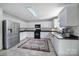 Spacious eat-in kitchen with white cabinets, stainless steel appliances, and tiled floor at 257 Notable Ln, Rock Hill, SC 29732