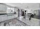 Kitchen with white cabinets, black appliances, an area rug, and access to living room at 257 Notable Ln, Rock Hill, SC 29732
