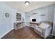 Cozy living room features a comfortable recliner, built-in shelving, and a serene atmosphere for relaxation at 257 Notable Ln, Rock Hill, SC 29732