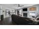 Open living space features wood floors, a fireplace, ceiling fan, and view to the kitchen at 257 Notable Ln, Rock Hill, SC 29732