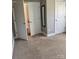 Bedroom with neutral carpet, white doors, and a mirror, providing a blank canvas for customization at 2608 Glyncastle Way, Gastonia, NC 28056