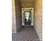 Close-up of front door with brick surround and decorative glass, creating a welcoming entrance at 2608 Glyncastle Way, Gastonia, NC 28056