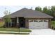 A charming single-story brick house featuring an attached two-car garage and manicured front lawn at 2608 Glyncastle Way, Gastonia, NC 28056