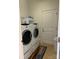 A laundry room featuring a white washer and dryer and a door to the exterior or another part of the home at 2608 Glyncastle Way, Gastonia, NC 28056
