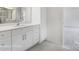 Bathroom featuring dual sinks, white cabinets, gray tile flooring at 2783 Ashton Park Ln # 67, Monroe, NC 28110