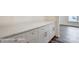 Stylish buffet with white cabinets, sleek hardware, and a spacious countertop, ideal for storage and serving in a home at 2783 Ashton Park Ln # 67, Monroe, NC 28110