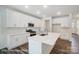 Modern kitchen boasts white cabinetry, a large island with a sink, and stainless steel appliances for a sleek design at 2783 Ashton Park Ln # 67, Monroe, NC 28110