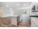 Open kitchen with island and stainless appliances and a door to the backyard at 2783 Ashton Park Ln # 67, Monroe, NC 28110
